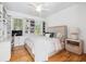 Bright bedroom featuring built-in shelving, hardwood floors, and a comfortable bed at 22 Frogmore Rd, Mount Pleasant, SC 29464