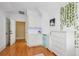 Bedroom featuring hardwood floors, white furniture, and natural light from a window at 22 Frogmore Rd, Mount Pleasant, SC 29464