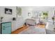Bright bedroom featuring hardwood floors, white furniture, and natural light at 22 Frogmore Rd, Mount Pleasant, SC 29464