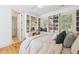 Bright bedroom featuring built-in shelving, hardwood floors, and a comfortable bed at 22 Frogmore Rd, Mount Pleasant, SC 29464