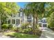 Beautiful two-story home with a wrap-around porch, lush landscaping, and a detached garage at 22 Frogmore Rd, Mount Pleasant, SC 29464