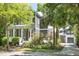 Inviting two-story home with a white-columned porch and landscaped front yard with mature trees at 22 Frogmore Rd, Mount Pleasant, SC 29464