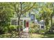 Charming two-story home with a inviting front porch, beautiful landscaping, and a bright red front door at 22 Frogmore Rd, Mount Pleasant, SC 29464