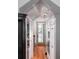 Hallway with wood floors, custom cabinets and built-in stainless oven and microwave at 22 Frogmore Rd, Mount Pleasant, SC 29464
