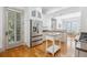 Bright kitchen with stainless appliances, white cabinets, and warm wood floors near dining area at 22 Frogmore Rd, Mount Pleasant, SC 29464