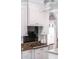 Close-up of a kitchen stovetop with white cabinets, granite countertops, and black tile backsplash at 22 Frogmore Rd, Mount Pleasant, SC 29464