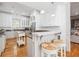 Bright kitchen with white cabinets and a breakfast bar, seamlessly connecting to the dining and living areas at 22 Frogmore Rd, Mount Pleasant, SC 29464