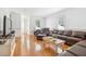 Spacious living room with hardwood floors, comfortable leather seating, and ample natural light from large windows at 22 Frogmore Rd, Mount Pleasant, SC 29464