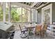 Outdoor dining area on a screened porch, complete with grill at 22 Frogmore Rd, Mount Pleasant, SC 29464