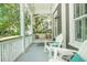 Inviting porch with a swing and white rocking chairs creating a cozy outdoor living space at 22 Frogmore Rd, Mount Pleasant, SC 29464