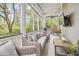 Screened porch with comfortable seating and lush greenery views at 22 Frogmore Rd, Mount Pleasant, SC 29464