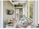 Cozy screened porch with wicker furniture, ceiling fan, and relaxing ambiance at 22 Frogmore Rd, Mount Pleasant, SC 29464
