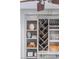 Close-up of living room shelving featuring wine storage, books, and home decor at 22 Frogmore Rd, Mount Pleasant, SC 29464