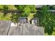 An aerial view displaying backyard patio spaces, partial tree coverage, and installed gutters at 259 Pine Shadow Dr, Goose Creek, SC 29445