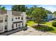 An aerial view shows assigned parking and the front exterior of a two-story townhouse unit at 259 Pine Shadow Dr, Goose Creek, SC 29445