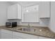 Well-lit kitchen area with granite countertops and ample storage, providing a functional and stylish cooking space at 259 Pine Shadow Dr, Goose Creek, SC 29445