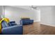Spacious living room with hardwood floors, featuring modern blue sofas with a ceiling fan and a view to the next room at 259 Pine Shadow Dr, Goose Creek, SC 29445