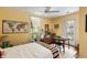 Cozy bedroom with a ceiling fan, bright light, wooden dresser, and exterior access at 2808 Ion Ave, Sullivans Island, SC 29482