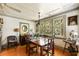 Charming dining room features wooden floors, bright light, and a view of the garden at 2808 Ion Ave, Sullivans Island, SC 29482