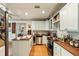 Well-lit kitchen features butcher block countertops, white cabinets, and stainless-steel appliances at 2808 Ion Ave, Sullivans Island, SC 29482