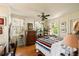 Bedroom includes a ceiling fan, windows, hardwood floors, and an accent chair at 2808 Ion Ave, Sullivans Island, SC 29482