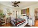 Bedroom with a bed, bedside table, ceiling fan, and an entryway to another room at 2808 Ion Ave, Sullivans Island, SC 29482