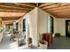 Spacious porch with exposed wood ceiling and ample seating at 2808 Ion Ave, Sullivans Island, SC 29482