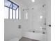 Bright bathroom showcasing a shower-tub with glass door and window at 281 Hawthorne St, Mount Pleasant, SC 29464