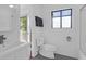 Clean bathroom featuring hexagon tile flooring, a window, and all-white fixtures at 281 Hawthorne St, Mount Pleasant, SC 29464