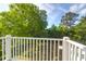 Deck area with white railing offering peaceful views of the backyard and trees at 281 Hawthorne St, Mount Pleasant, SC 29464