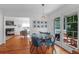 Airy dining room with wood floors and a door leading to a screened-in porch at 281 Hawthorne St, Mount Pleasant, SC 29464