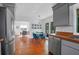 Open dining room with wood floors leads to kitchen and screened-in porch at 281 Hawthorne St, Mount Pleasant, SC 29464