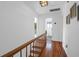 Hallway with wood floors, white walls, and access to a bathroom at 281 Hawthorne St, Mount Pleasant, SC 29464