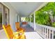 Relaxing porch with a pair of rocking chairs overlooking the lush green foliage at 281 Hawthorne St, Mount Pleasant, SC 29464