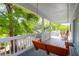 Relaxing porch swing overlooking lush green foliage and the neighborhood at 281 Hawthorne St, Mount Pleasant, SC 29464