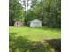 Wide backyard with storage sheds, perfect for outdoor projects and storage in a nature filled setting at 298 Summerset Ln, Summerville, SC 29483