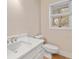 Modern half bathroom featuring a quartz countertop vanity and natural light, with blinds at 298 Summerset Ln, Summerville, SC 29483