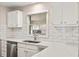 Updated kitchen featuring modern appliances, stylish backsplash, and a sunlit window at 298 Summerset Ln, Summerville, SC 29483