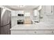 Bright kitchen with stainless appliances, white cabinets, and countertops overlooking backyard and laundry at 298 Summerset Ln, Summerville, SC 29483