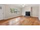 Bright living room boasts hardwood floors, a cozy fireplace, and large window offering natural light at 298 Summerset Ln, Summerville, SC 29483