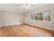 Bright living room with large windows and hardwood floors, offering ample natural light and scenic views at 298 Summerset Ln, Summerville, SC 29483