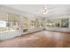 Bright sunroom featuring natural light, hardwood floors, and multiple windows offering views of the landscaped property at 298 Summerset Ln, Summerville, SC 29483