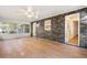 Enclosed sunroom featuring brick accent wall, hardwood floors, fan, and bright windows offering ample natural light at 298 Summerset Ln, Summerville, SC 29483