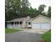 Inviting ranch-style home with a charming front porch and a two-car garage on a large lot at 302 Summerset Ln, Summerville, SC 29483