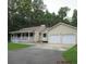 Ranch-style home with a two-car garage, porch, and well-maintained lawn and landscaping at 302 Summerset Ln, Summerville, SC 29483