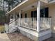 Charming front porch with white railings, perfect for enjoying the outdoors and neighborhood views at 302 Summerset Ln, Summerville, SC 29483