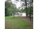Well-maintained front yard with mature trees offering shade and privacy to the property at 302 Summerset Ln, Summerville, SC 29483