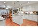 Open kitchen design with island, granite countertops, and hardwood floors extending to the dining area at 302 Summerset Ln, Summerville, SC 29483