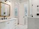 Bright bathroom featuring a modern vanity, decorative mirror, and glass-enclosed shower at 305 N Civitas St, Mount Pleasant, SC 29464
