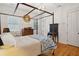 Bright bedroom features a four-poster bed, hardwood floors, and paneled walls at 305 N Civitas St, Mount Pleasant, SC 29464